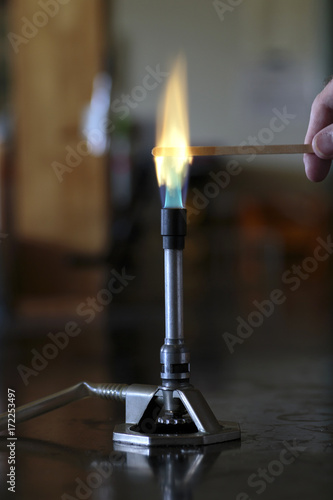 Fotografie Barium solution burning on a wooden splint in a bunsen burner flame
