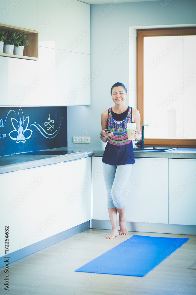 Portrait of a beautiful sports woman using smartphone. Woman. Yoga. Sport Portrait of a beautiful sports woman using smartphone. Woman. Yoga. Sport