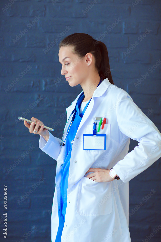 Young woman doctor sitting with your phone. Woman doctors. Young woman doctor sitting with your phone. Woman doctors.