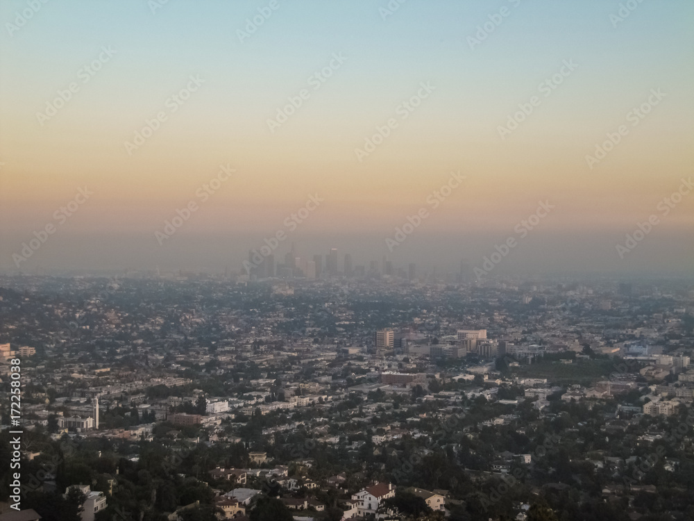 Cityscape or skyline of the LA city with smog during sunrise or sunset in Los Angeles
