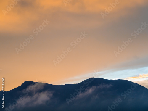 Colorful Sky and Clouds drifting over the forest mountain in evening time