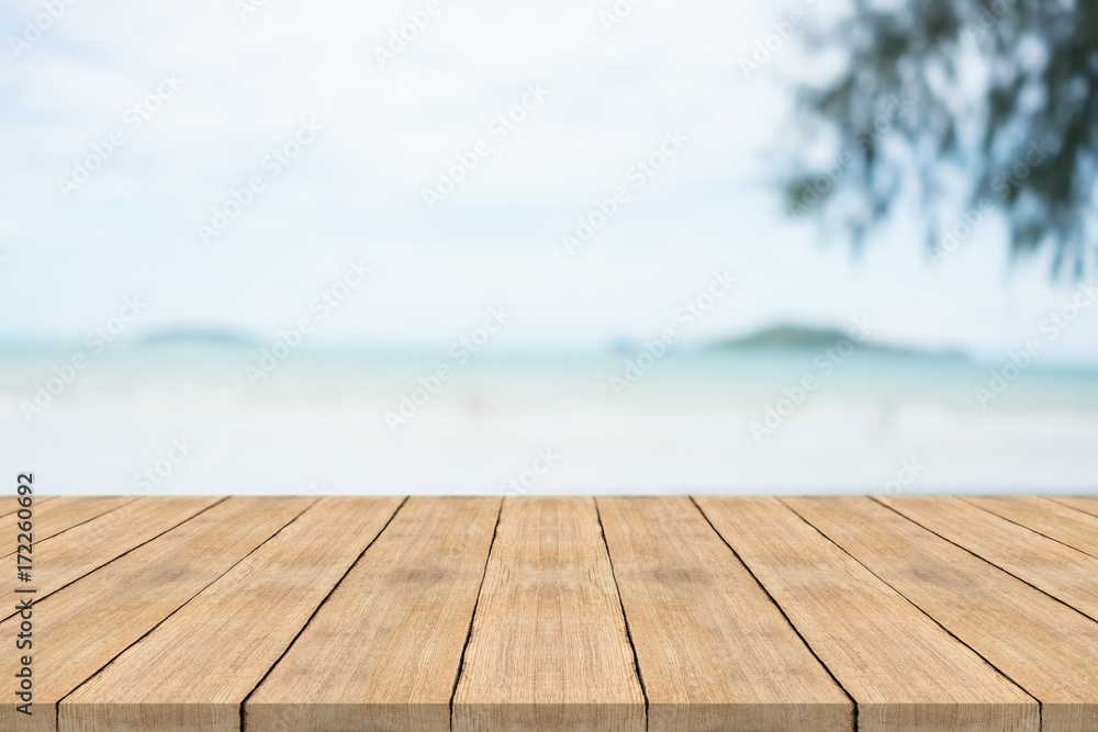 Empty wooden table in front with blurred background at the beach,space for montage you products