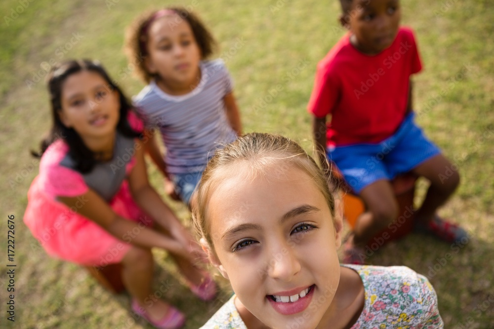 High angle view of children sitting in yard High angle view of children sitting in yard