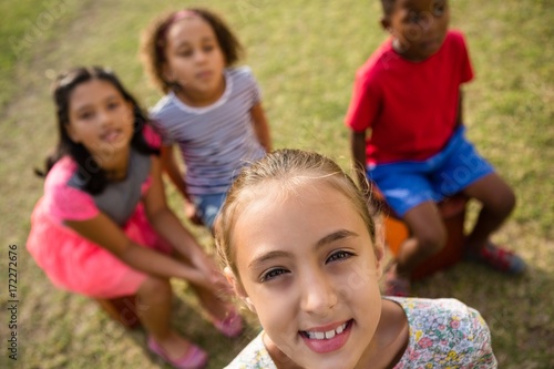 High angle view of children sitting in yard