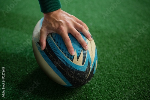 Cropped hand of person with rugby ball