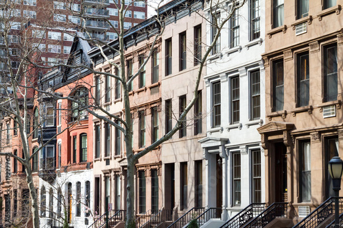 Row of historic brownstone buildings along a block in Manhattan, New York City