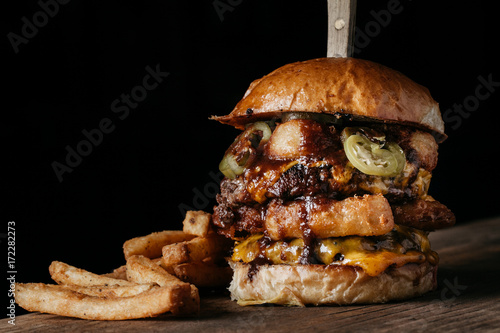 Juicy Burger with onion rings and pickled jalapenos