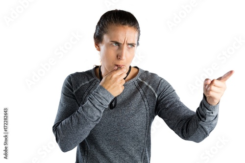 Female coach gesturing while whistling © WavebreakMediaMicro