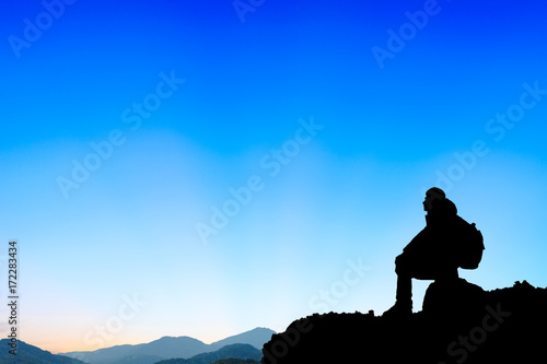 Silhouette of a man on the mountain at sunset