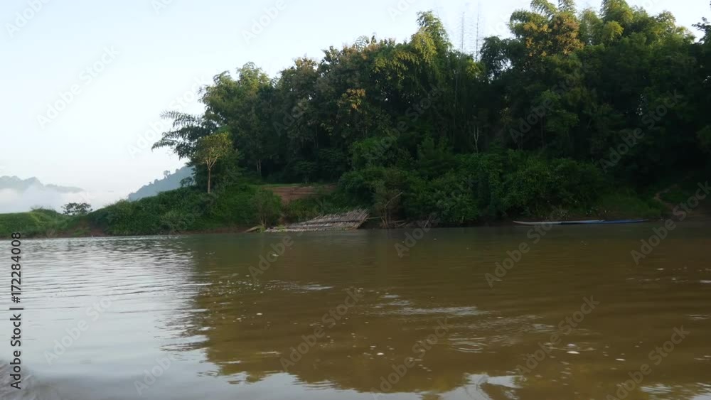 On the river in the morning with mist in Laos On the river in the morning with mist in Laos