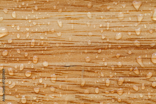 water drops on a brown wooden surface