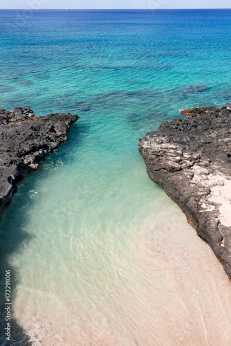 A sandy tide pool in Hawaii with crystal clear waters