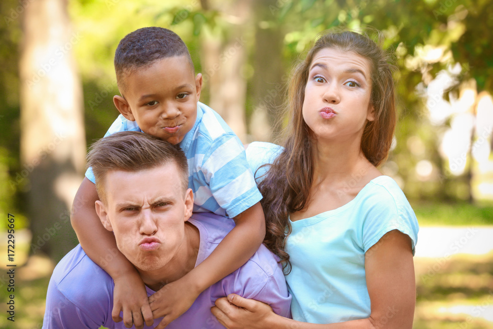 Young family with adopted African American boy having fun outdoors Young family with adopted African American boy having fun outdoors