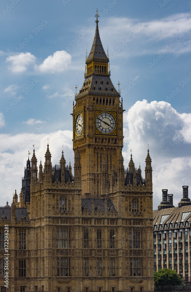 Vertical isolated view of the famous Big Ben Clock Tower in London, England against perfect fluffy clouds.