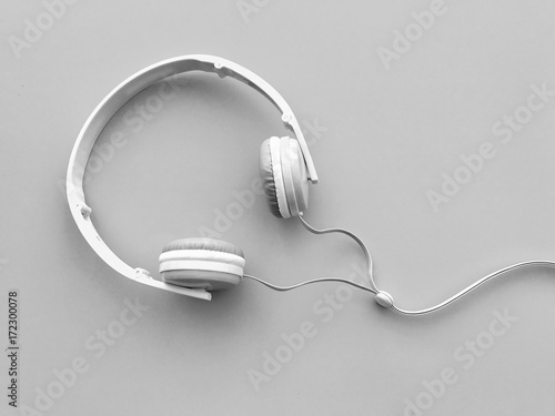 Closeup A white headphone on light gray background. Gadgets on gray background. Top view with Copy space. Selective focus. photo