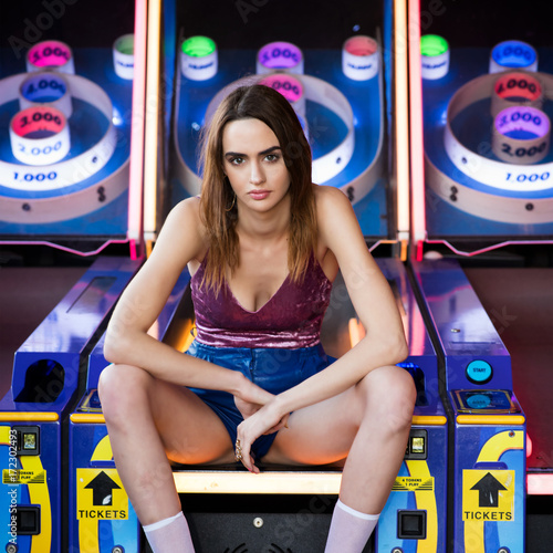 Street style fashion at the arcade. Crushed velvet tank top, bluish leather pants and platform heals.
