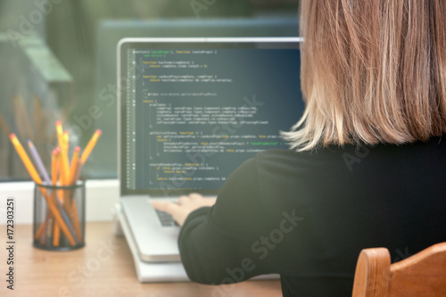 Obraz na płótnie woman freelance programmer working from home. website code on screen.