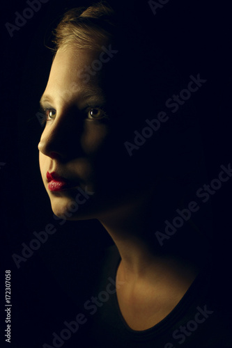 Fashion Beauty Model Girl Portrait Over Black. Beautiful Girl Over Black Background. Portrait of Beautiful Young Girl Close-up. 
