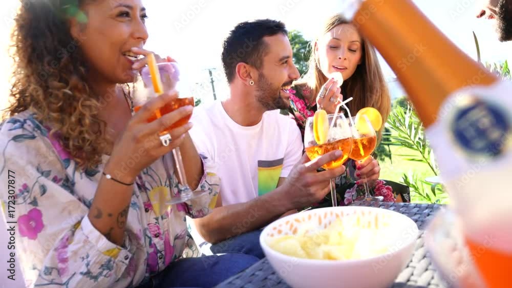 Group of friends cheering with summer cocktails Group of friends cheering with summer cocktails