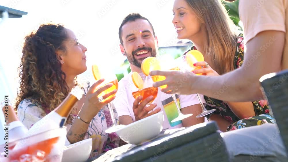 Group of friends cheering with summer cocktails Group of friends cheering with summer cocktails