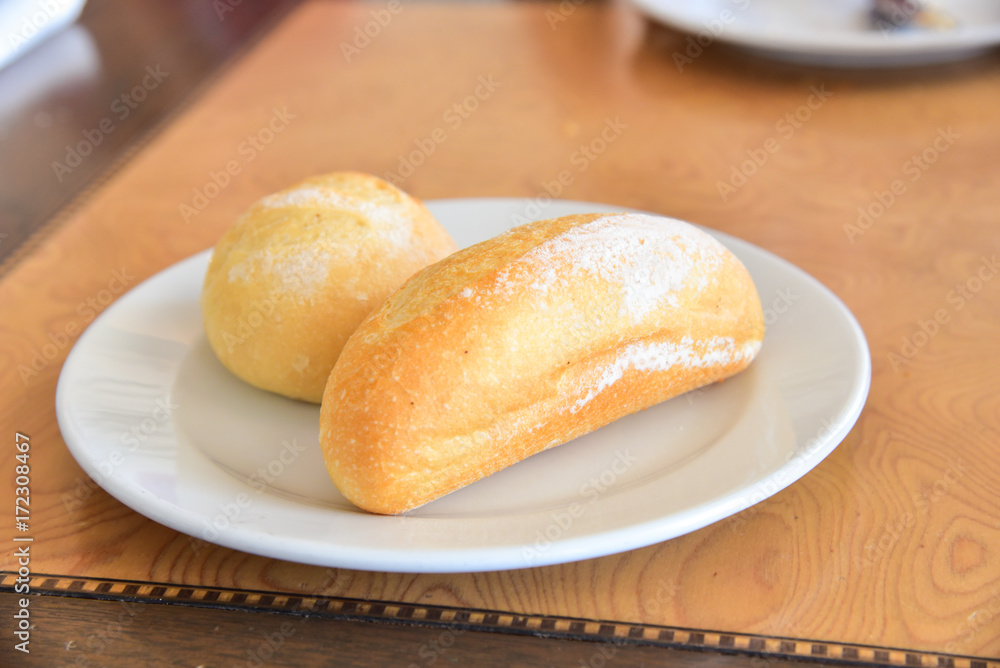 French Baguette and Bread Roll Isolated on White Plate French Baguette and Bread Roll Isolated on White Plate