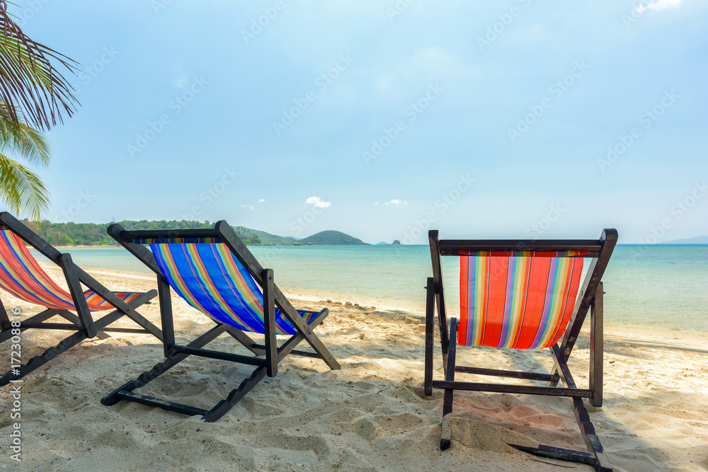 Beach chairs on the white sand beach and tropical sea