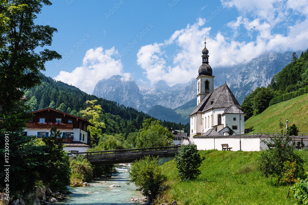 Scenic view of small white church against mountains