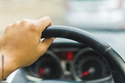Close up Speedometer and hand holding steering wheel of car dashboard. driving, Transportation, concept © Annop