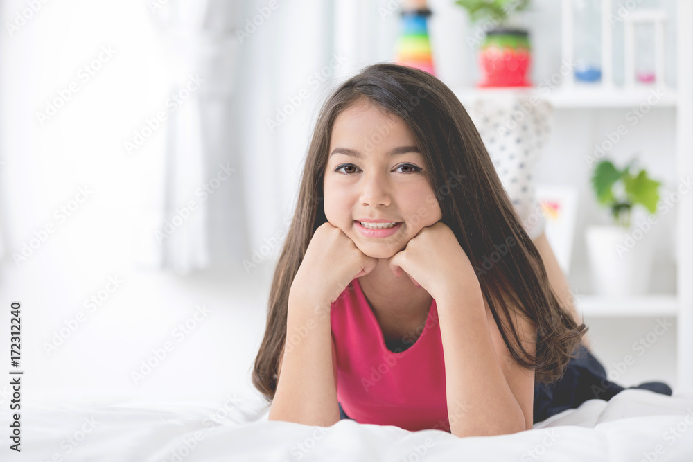 Portrait of asian cute girl rest on the bed and looking a camera Portrait of asian cute girl rest on the bed and looking a camera