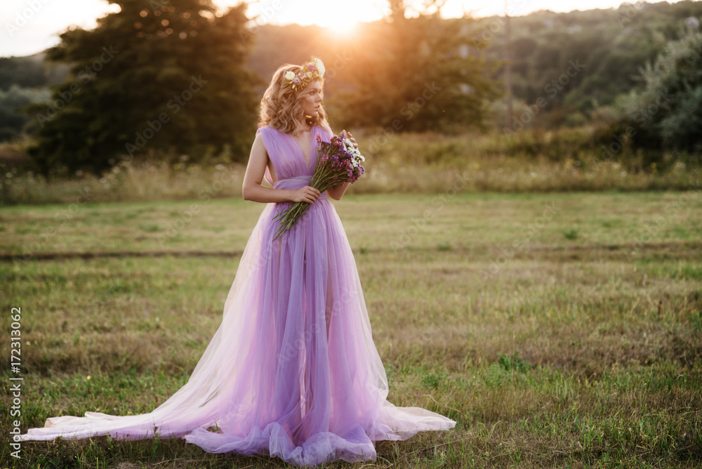 beauty woman portrait with wreath of flowers on head at sunset. bride in purple dress Outdoor. soft focus beauty woman portrait with wreath of flowers on head at sunset. bride in purple dress Outdoor. soft focus