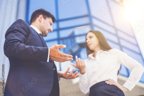 The business woman and man arguing near the modern building