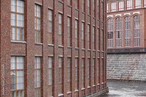 Old red brick facade factory buildings in Tampere, Finland. photo