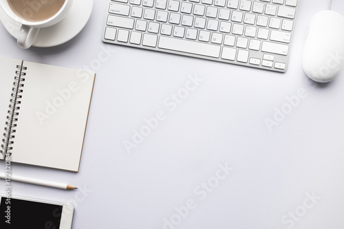 Business table top with mock up office supplies and male hand on white background.Flat lay design.Copy space