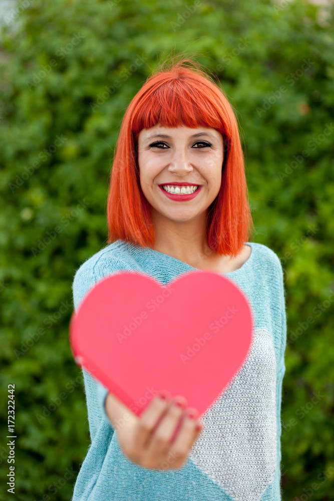 Relaxed red haired woman in the park