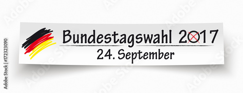 Papierzettel mit einer deutschen Fahne und dem Text Bundestagswahl 2017 24. September