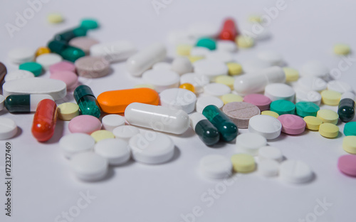 Various medications and vitamins, a pill bottle. Pastel background, place to insert your text. Health and pharmacy.