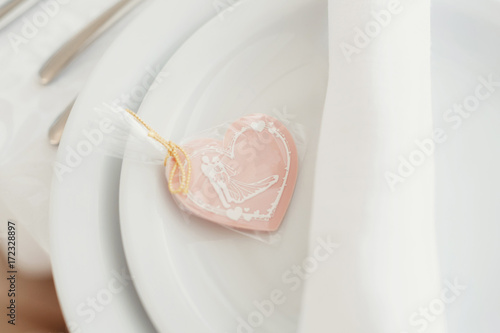Pink cookie with wedding couple on the top