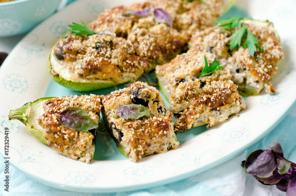 Baked zucchini stuffed with cheese and black olives