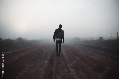 Man walking on misty path photo