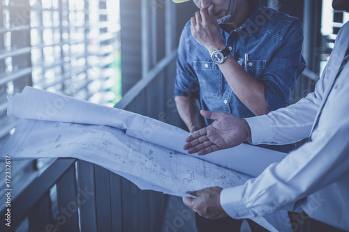 architect and engineer inspect housing estate building to success construction plan before send quality housing to customers ; smart team discuss and review construction plan