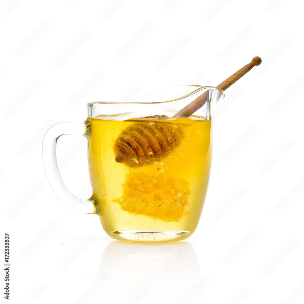 golden honey and wooden stick in the glass golden honey and wooden stick in the glass