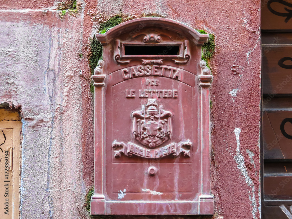 Old red mailbox on the street of Rome, Italy