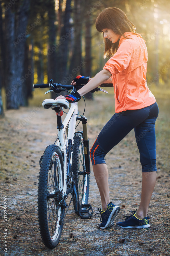 cyclist cycling mountain bike on Pine forest trail cyclist cycling mountain bike on Pine forest trail