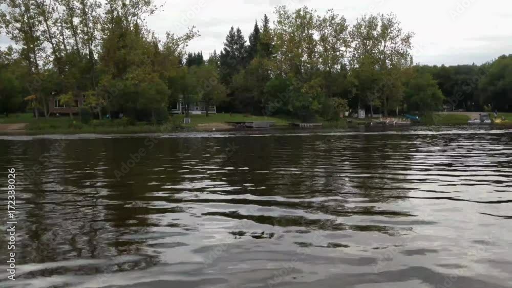 Clip taken from a pontoon cruise boat enjoying a scenic river boat cruise while looking at the dwellings along side the river. Clip taken from a pontoon cruise boat enjoying a scenic river boat cruise while looking at the dwellings along side the river.