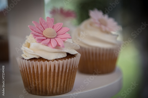 Wedding cupcake with a pink daisy