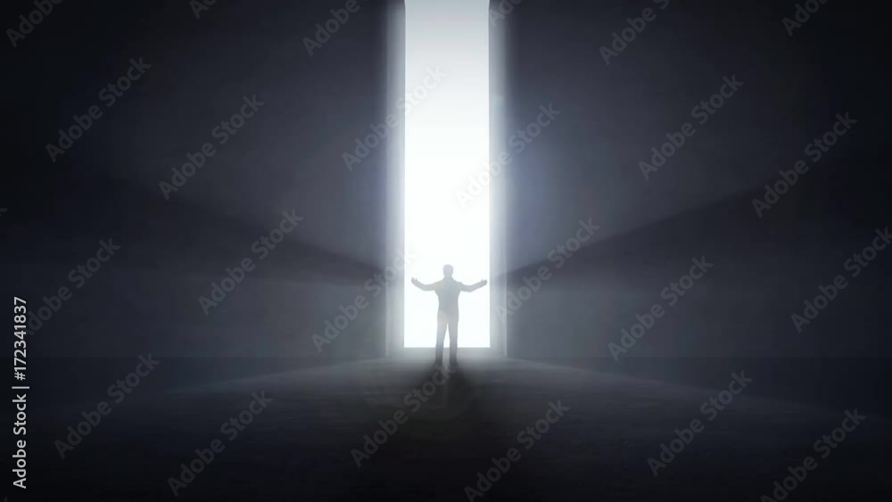 Man standing at an opening light tunnel's entrance raising his hands up