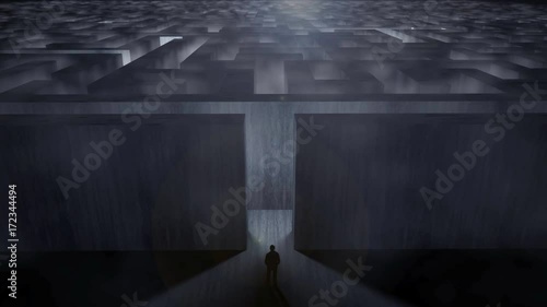 Man standing at the entrance of a gigantic labyrinth in a dramatic environment with fog