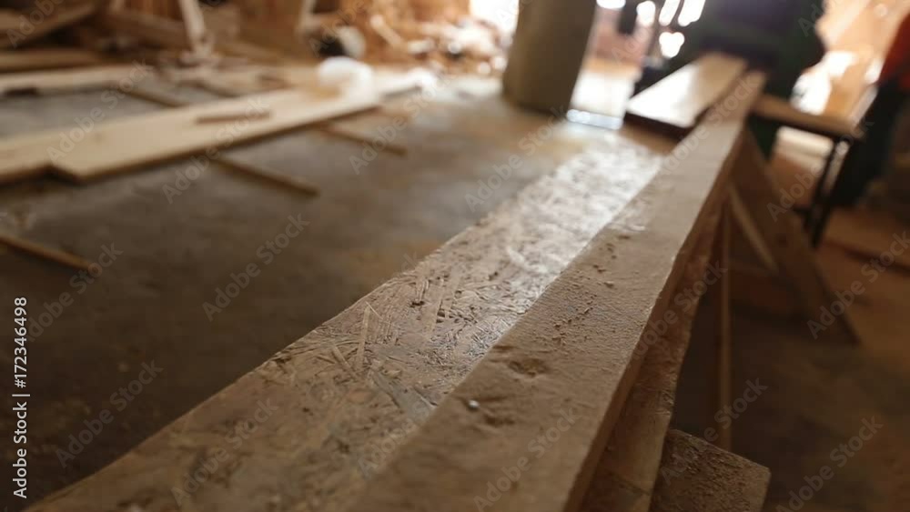 Circular saw cutting through a plank of wood Circular saw cutting through a plank of wood