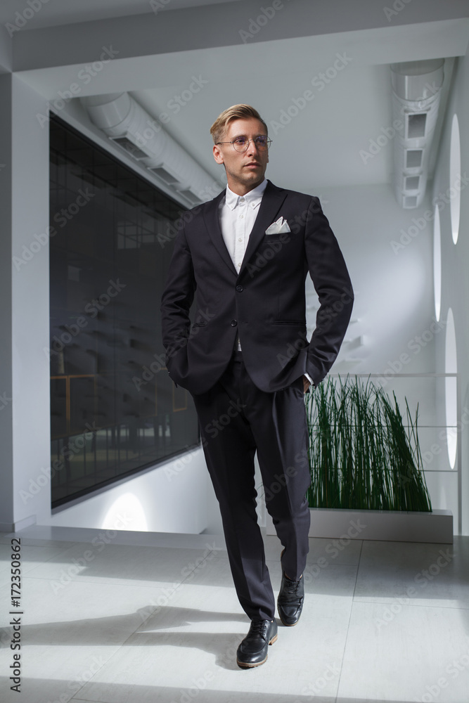 Confident gentleman walking in office Confident gentleman walking in office