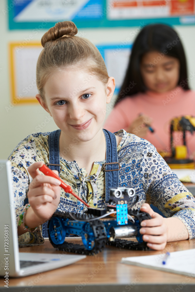 Fototapeta premium Portrait Of Female Pupil In Science Lesson Studying Robotics